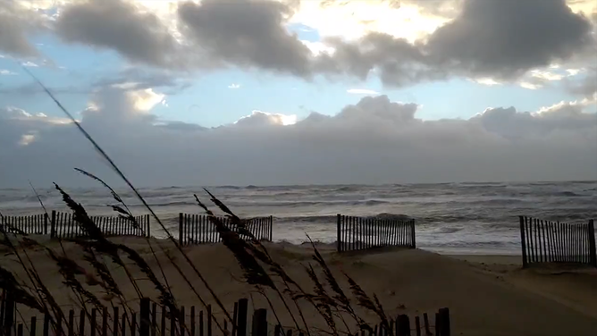 Sea oats blow in the wind in Avon Beach, North Carolina, on Saturday morning.