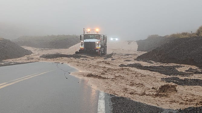 Rocks, mud and floodwater being cleared from highway 190 after heavy rains hit Death Valley National Park early evening August 20.