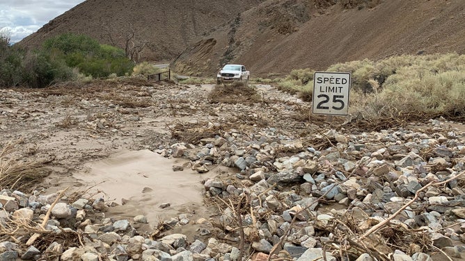 Debris completely covers a paved road near Wildrose Campground in Death Valley National Park.