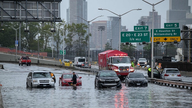 Cars in floodwater on the FDR highway in Manhattan, New York on September 29, 2023.