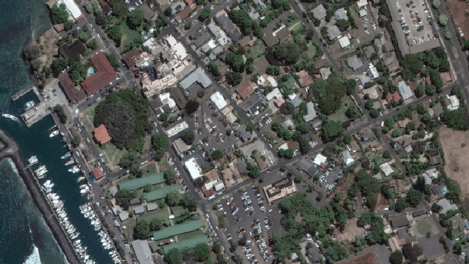 Satellite imagery of Lahaina before and after the wildfire. Note the location of the once-lush Banyan Tree on the left side near the water and red-roofed building.