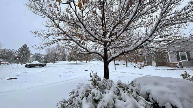 Snow is seen covering roads and trees in the Denver area on Sunday, October 29, 2023.