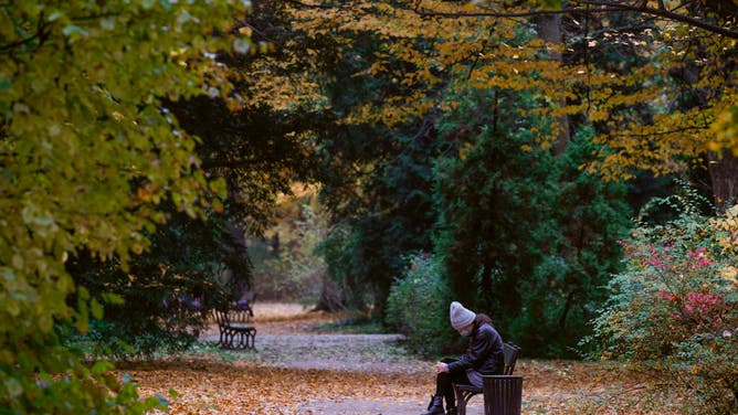 File photo: A woman is seen sitting on a bench n the Royal Baths park in Warsaw, Poland on October 31, 2020.