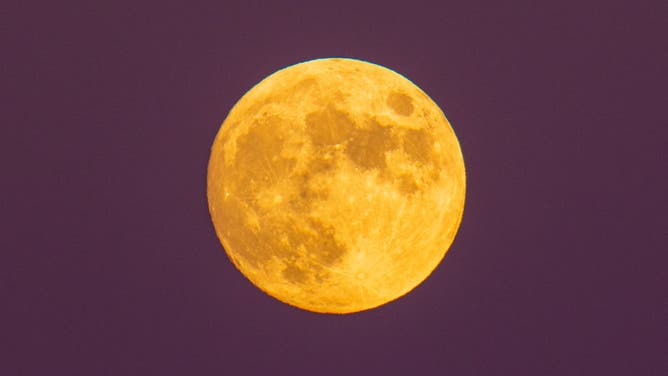 Beaver moon rising behind Gran Sasso dItalia picks is seen from LAquila, Italy, on November 7, 2022.