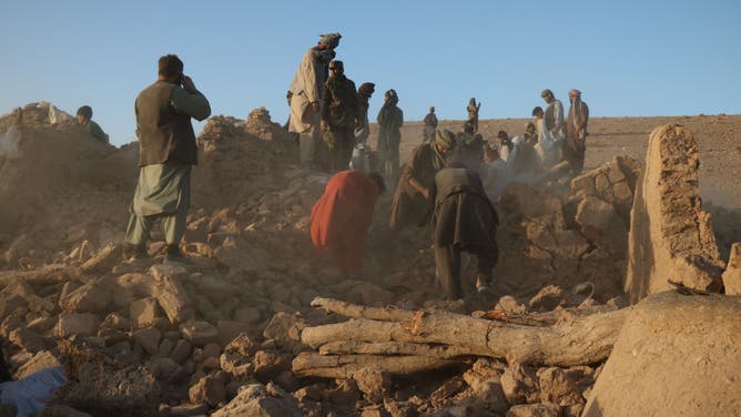 Afghan residents clear debris from a damaged house after earthquake in Sarbuland village of Zendeh Jan district of Herat province on October 7,2023.