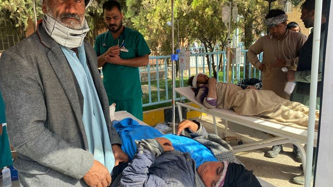 A medic and volunteers attend injured survivors at a hospital following earthquake in Herat on October 15, 2023.