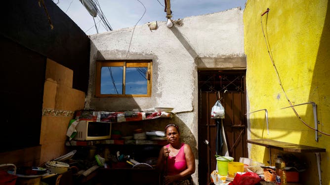 Paula Hernandez stands at a destroyed house after the passage of Hurricante Otis in Puerto Marques, Guerrero State, Mexico, on October 27, 2023. The death toll from an extraordinarily powerful hurricane that blasted the Mexican resort city of Acapulco rose Saturday to 39, the Mexican government said. (Photo by Rodrigo OROPEZA / AFP) (Photo by RODRIGO OROPEZA/AFP via Getty Images)