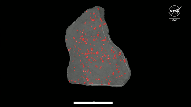 Using X-ray computed tomography, scientists can see sulfide minerals (in red) inside of a piece of rock from the Bennu sample without cutting into the rock.