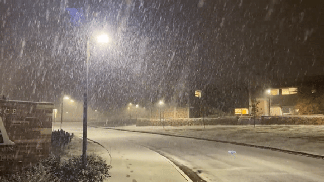 A photo showing snow falling outside the National Weather Service office in Boulder, Colorado.