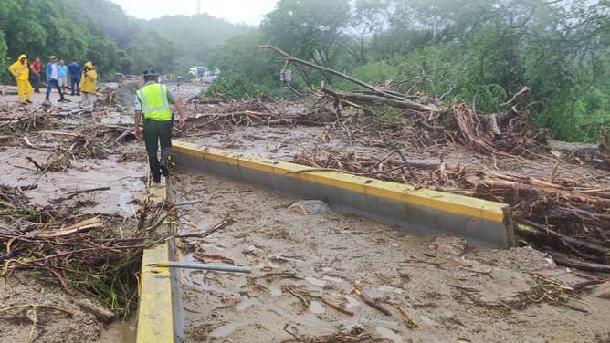 Roadways blocked trying to reach hard-hit coastal town in Mexico from Hurricane Otis.