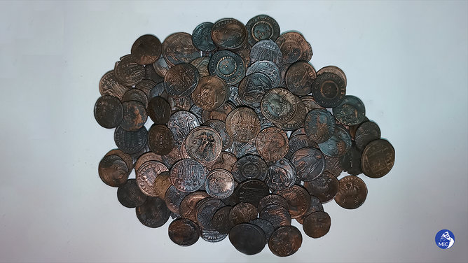 As many as 50,000 bronze coins dating back to the 4th century AD have been discovered by a diver off the coast of Sardinia, the Italian ministry of culture said.