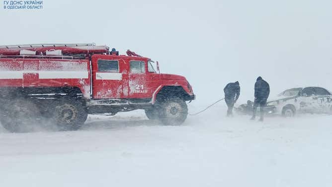 A car is pulled from the snow in Odessa, Ukraine on Sunday, Nov. 26, 2023.
