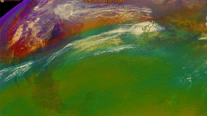 In this image from the GOES-16 (GOES East) satellite, the green area is warm, moist tropical air, while the orange and red areas are cold, dry polar air. The moving band of air between the two is the polar jet stream.