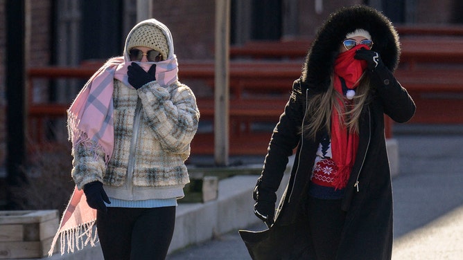 FILE -- People walk in freezing cold temperatures on February 4, 2023 in New York City.