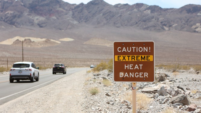 FILE - A heat advisory sign is shown along US highway 190 during a heat wave in Death Valley National Park in Death Valley, California, on July 16, 2023. Tens of millions of Americans braced for more sweltering temperatures Sunday as brutal conditions threatened to break records due to a relentless heat dome that has baked parts of the country all week. By the afternoon of July 15, 2023, Californias famous Death Valley, one of the hottest places on Earth, had reached a sizzling 124F (51C), with Sundays peak predicted to soar as high as 129F (54C). Even overnight lows there could exceed 100F (38C). (Photo by Ronda Churchill / AFP) (Photo by RONDA CHURCHILL/AFP via Getty Images)