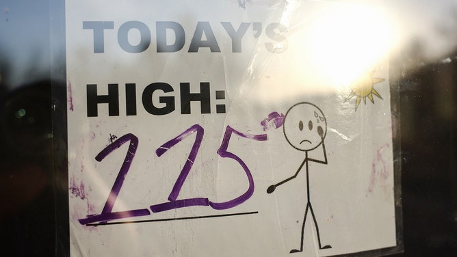 FILE -- A sign reading 'Today's High: 115' is posted in South Mountain Park amid the city's worst heat wave on record on July 25, 2023 in Phoenix, Arizona.