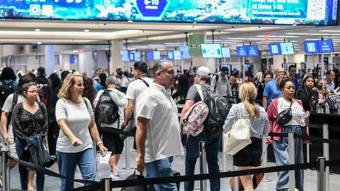 Travelers make their way through Orlando International