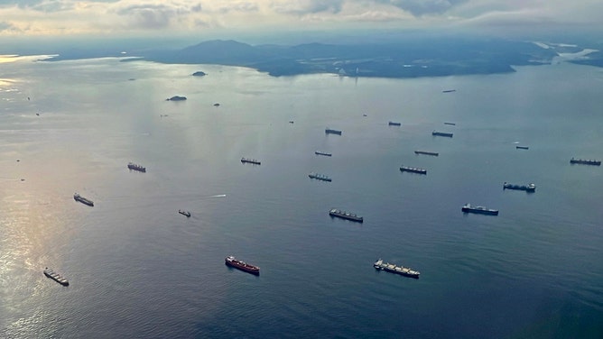 This aerial picture shows dozens of ships waiting to cross the Panama Canal as it maintains restrictions on the crossing of vessels due to a drought in Panama City, on September 10, 2023.