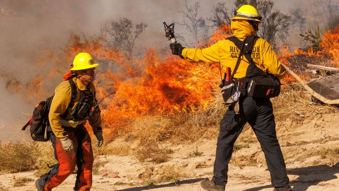 Firefighters battle the Highland Fire in Aguanga, California, US, on Tuesday, Oct. 31, 2023.