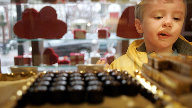 Richard Murphy looks through the glass at chocolates on Valentine's Day at the Belgian shop 'Leonidas' 14 February 2005 in Washington, DC.