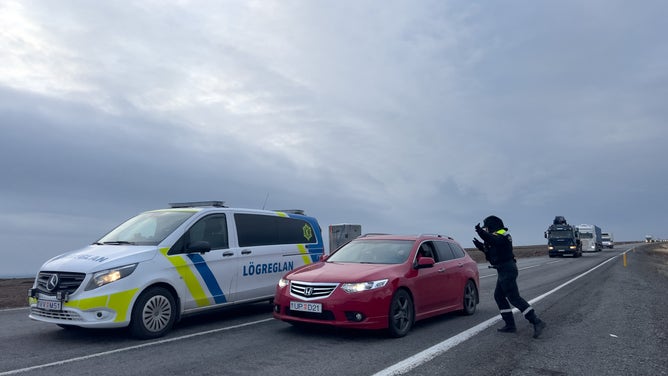 GRINDAVIK, ICELAND - NOVEMBER 14: Police direct traffic out of Grindavik on November 14, 2023 in Grindavik, Iceland. For the second day residents were allowed in to quickly collect personal belongings. (Photo by Micah Garen/Getty Images)