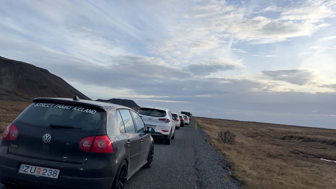 GRINDAVIK, ICELAND - NOVEMBER 14: Residents wait in a long line of cars to get into Grindavik to collect personal items on November 14, 2023 in Grindavik, Iceland. For the second day residents were allowed in to quickly collect personal belongings. (Photo by Micah Garen/Getty Images)