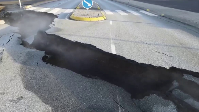 A large crack is seen cutting across a road in Grindavik, Iceland, amid fears that a volcano could erupt at any time.