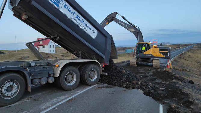 Crews are seen trying to fill cracks that formed amid earthquake activity near Grindavik, Iceland.