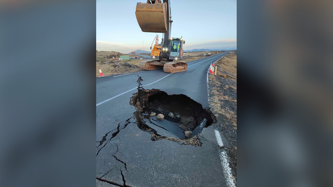 A large hole is seen in a road in Grindavik, Iceland.