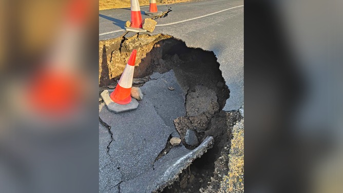 A large hole is seen in a road near Grindavik in Iceland amid fears of a volcanic eruption.