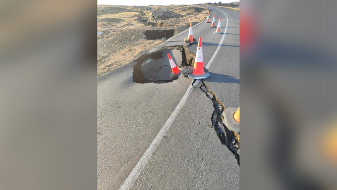 A large crack and hole is seen in a road near Grindavik in Iceland amid fears of a volcanic eruption.