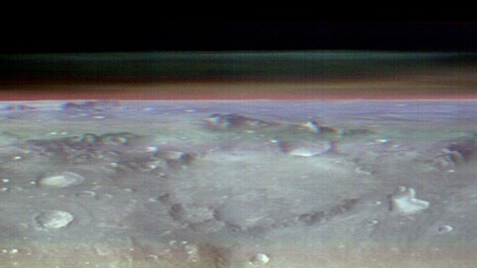 Odyssey's THEMIS Views the Horizon of Mars: This unusual view of the horizon of Mars was captured by NASA’s Odyssey orbiter using its THEMIS camera, in an operation that took engineers three months to plan. It’s taken from about 250 miles above the Martian surface – about the same altitude at which the International Space Station orbits Earth. Credit: NASA/JPL-Caltech/ASU.