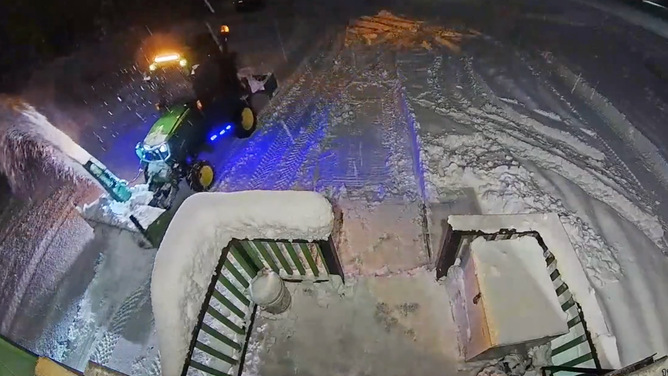 A John Deere tractor plows snow in Anchorage, Alaska.