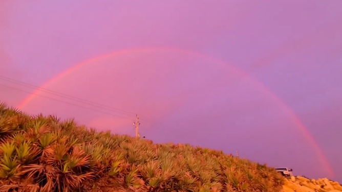 Pink clouds and rainbow over Florida.