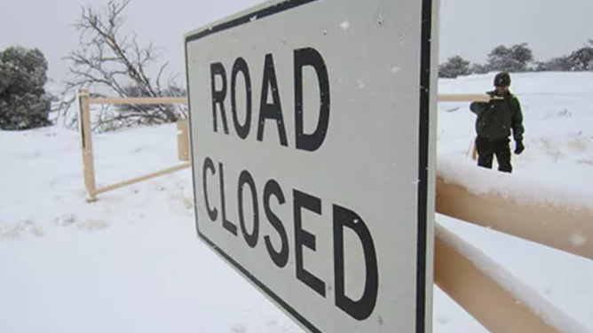 FILE: Road closure sign at Canyonlands National Park in snowy conditions.