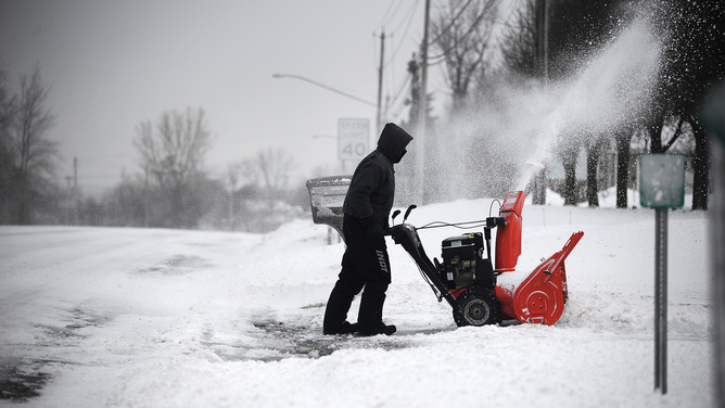 FILE: Keith Wojciechowski clears his driveway on December 24, 2022 in Hamburg, New York. (Photo by John Normile/Getty Images)
