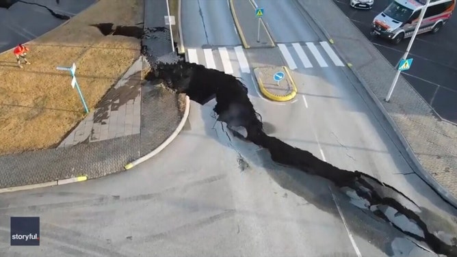 Footage filmed by Ragnar Visage shows steam rising from a crack in the street and a nearby parking lot at the intersection of Austervegur and Stamphólsvegur streets in Grindavik.