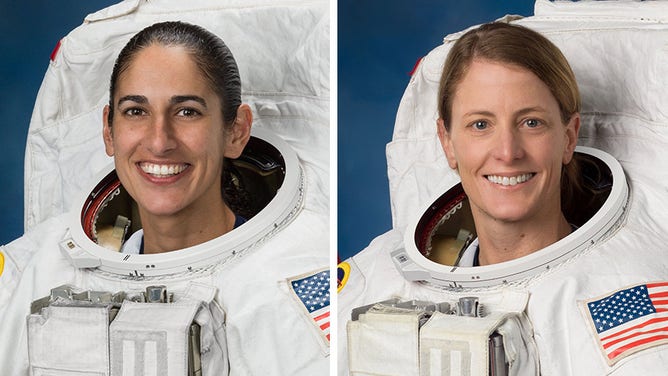(From left) Astronauts Jasmin Moghbeli and Loral O’Hara pose for portraits in spacesuits at the Johnson Space Center in Houston, Texas.