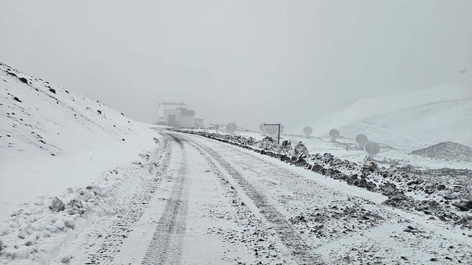 Snow continued to fall Thursday on the summit of Mauna Kea Observatory. The road to the summit is closed until further notice due to icy conditions.