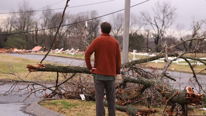 A man is seen observing the destruction left behind after a deadly tornado outbreak in Tennessee on Saturday, Dec. 9, 2023.