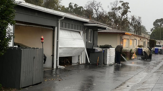 Garage doors are buckled from the force of floodwaters here in Port Hueneme, CA. Heavy rain caused nearby drainages to overflow, forcing evacuations. Luckily the waters have largely gone down here.