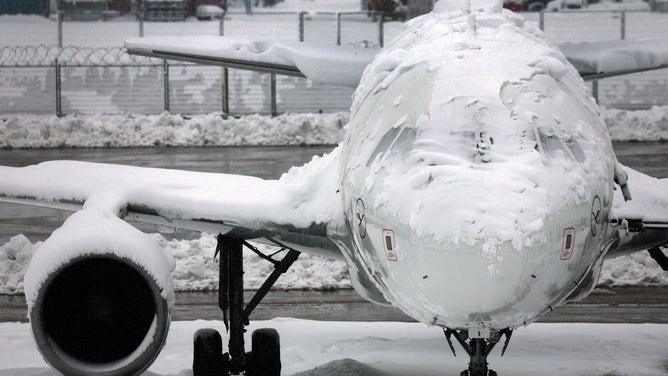 02 December 2023, Bavaria, Munich: A snow-covered plane stands at the airport. The closure of flight operations at Munich Airport has been extended until 03.12.2023 at 6.00 a.m. due to heavy snowfall. Photo: Karl-Josef Hildenbrand/dpa (Photo by Karl-Josef Hildenbrand/picture alliance via Getty Images)