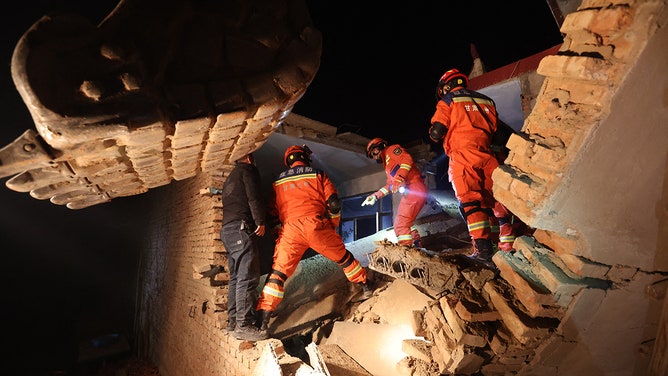Rescue workers search a house for survivors after an earthquake in Kangdiao village, Dahejia, Jishishan County, in northwest China's Gansu province on December 19, 2023.