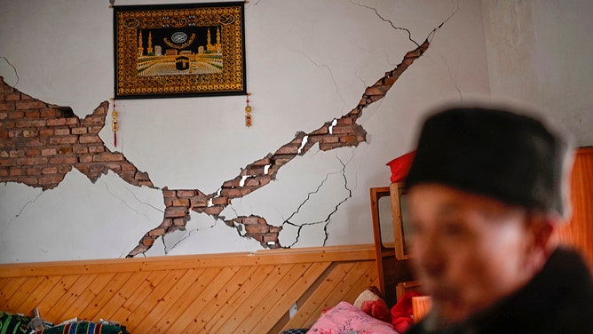 A man shows the damage to his home after an earthquake in Dahejia, Jishishan County in northwest China's Gansu province on December 19, 2023.