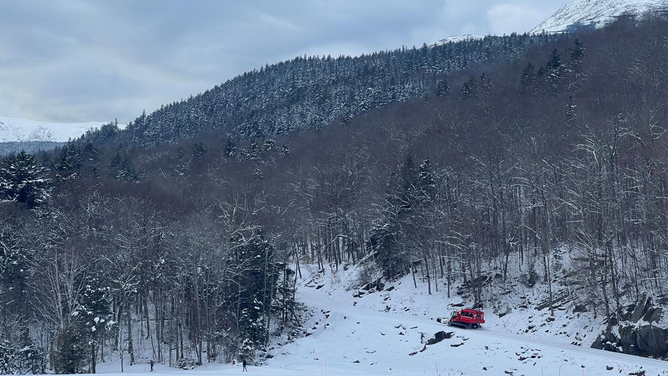 A "SnoCat" begins to ascend New Hampshire's Mount Washington to help rescue an injured skier.