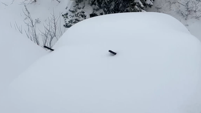 A vehicle buried in snow in Little Cottonwood Canyon, Utah. Dec. 4, 2023.