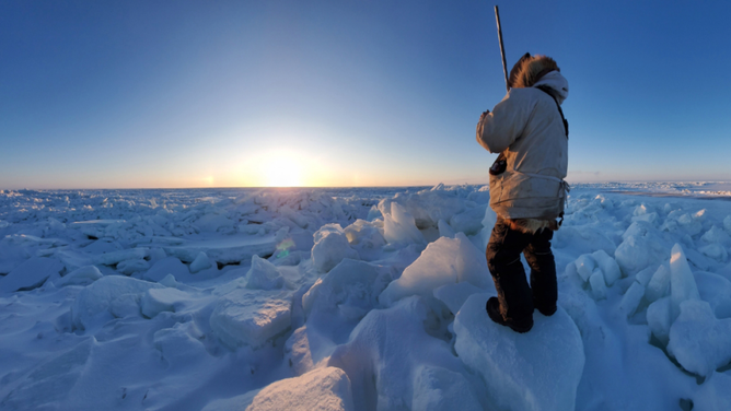 Guy Omnik observing the sea ice near Point Hope, Alaska, in January 2020 as part of the Alaska Arctic Observatory and Knowledge Hub. (Image credit: Caroline Nashookpuk)