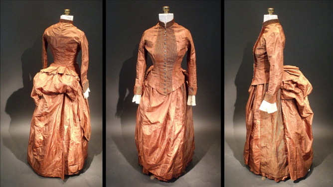  Three views of the 1880s silk bustle dress in which crumpled bits of paper containing a code were found. The pocket where the code was found is located under the overskirt at the right hip. (Image credit: Sara Rivers Cofield)