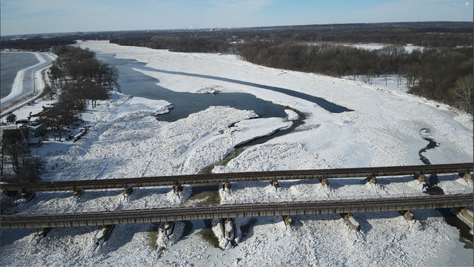 Siphon channels, looking west, are frozen over Monday in Will County, Illinois.
