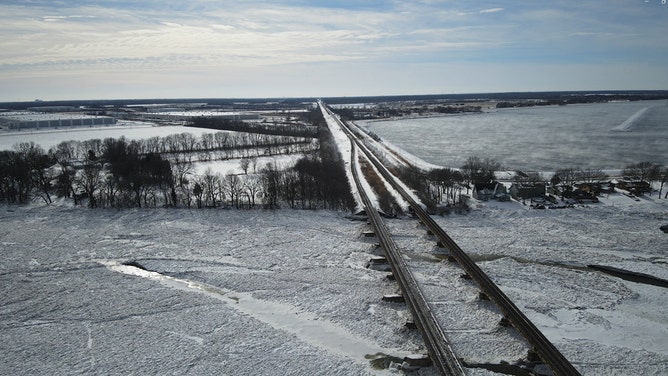 Siphon channels, looking west, are frozen over Monday in Will County, Illinois.